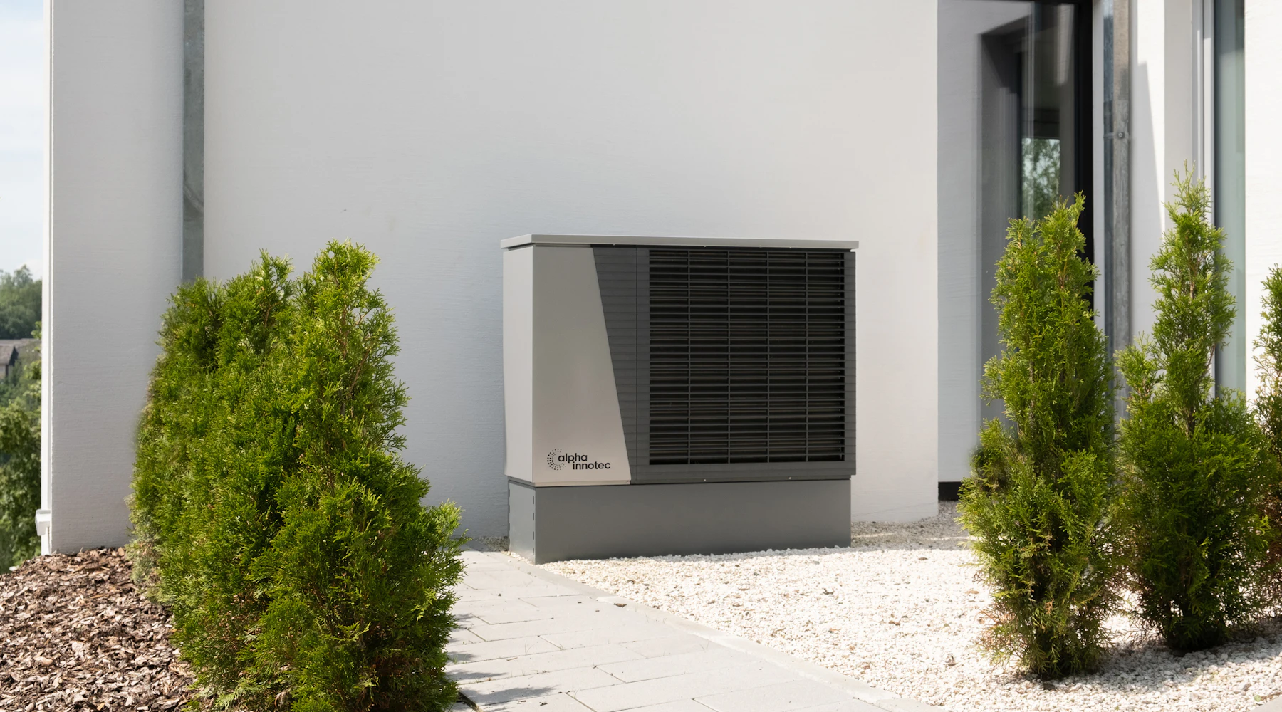 Air conditioning condenser mounted outside a home