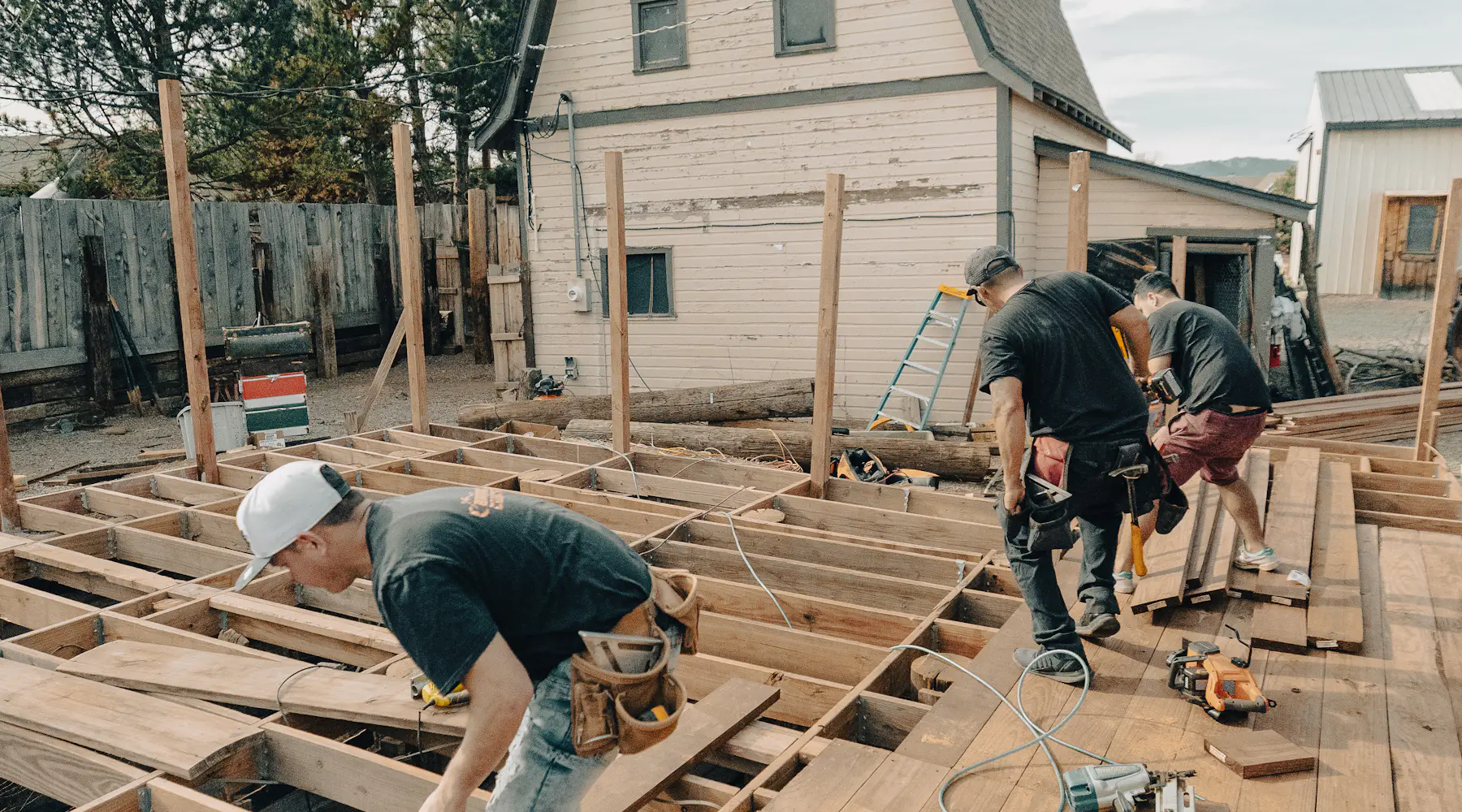 Carpenters replacing wood framing on a home