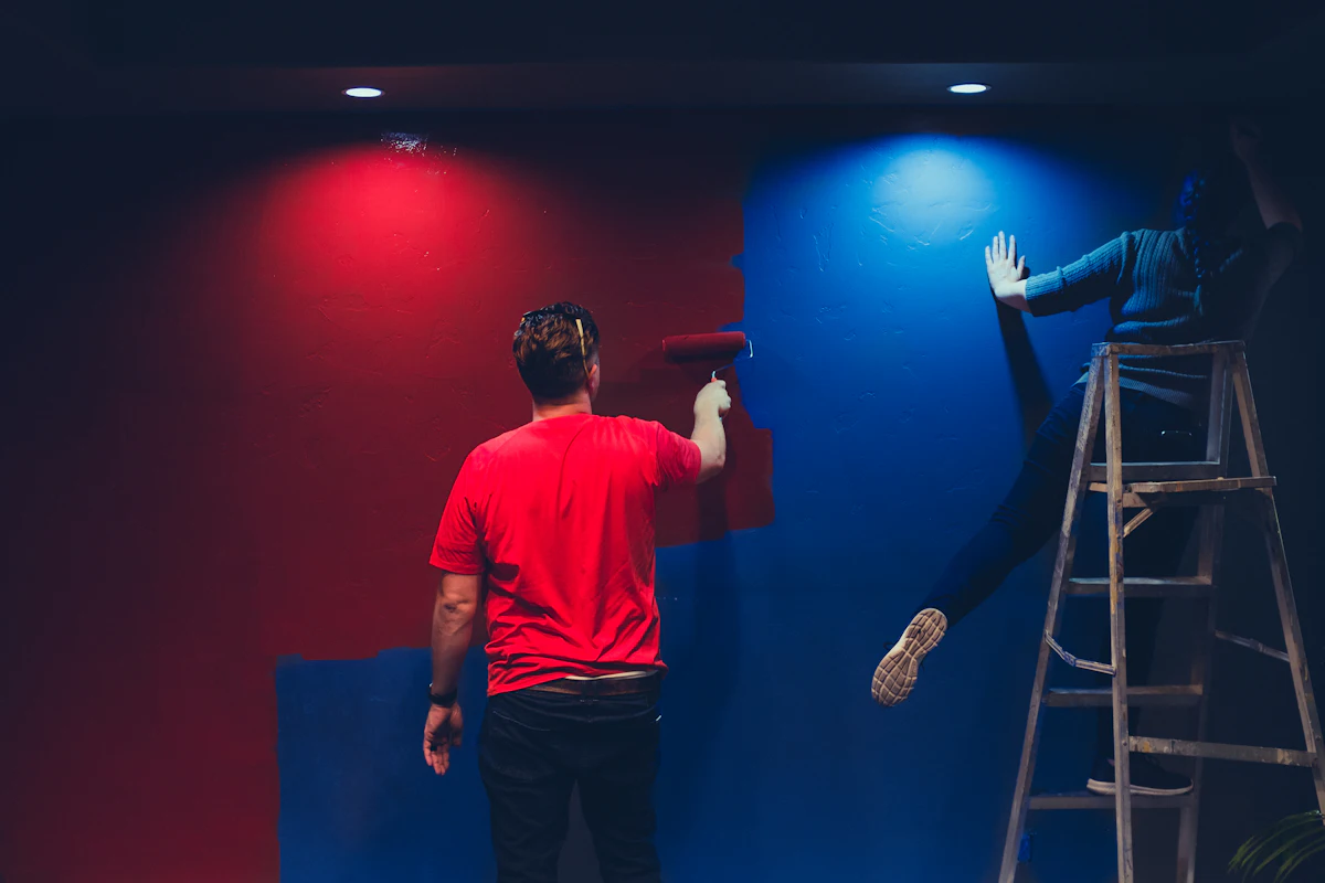 Two people painting a room